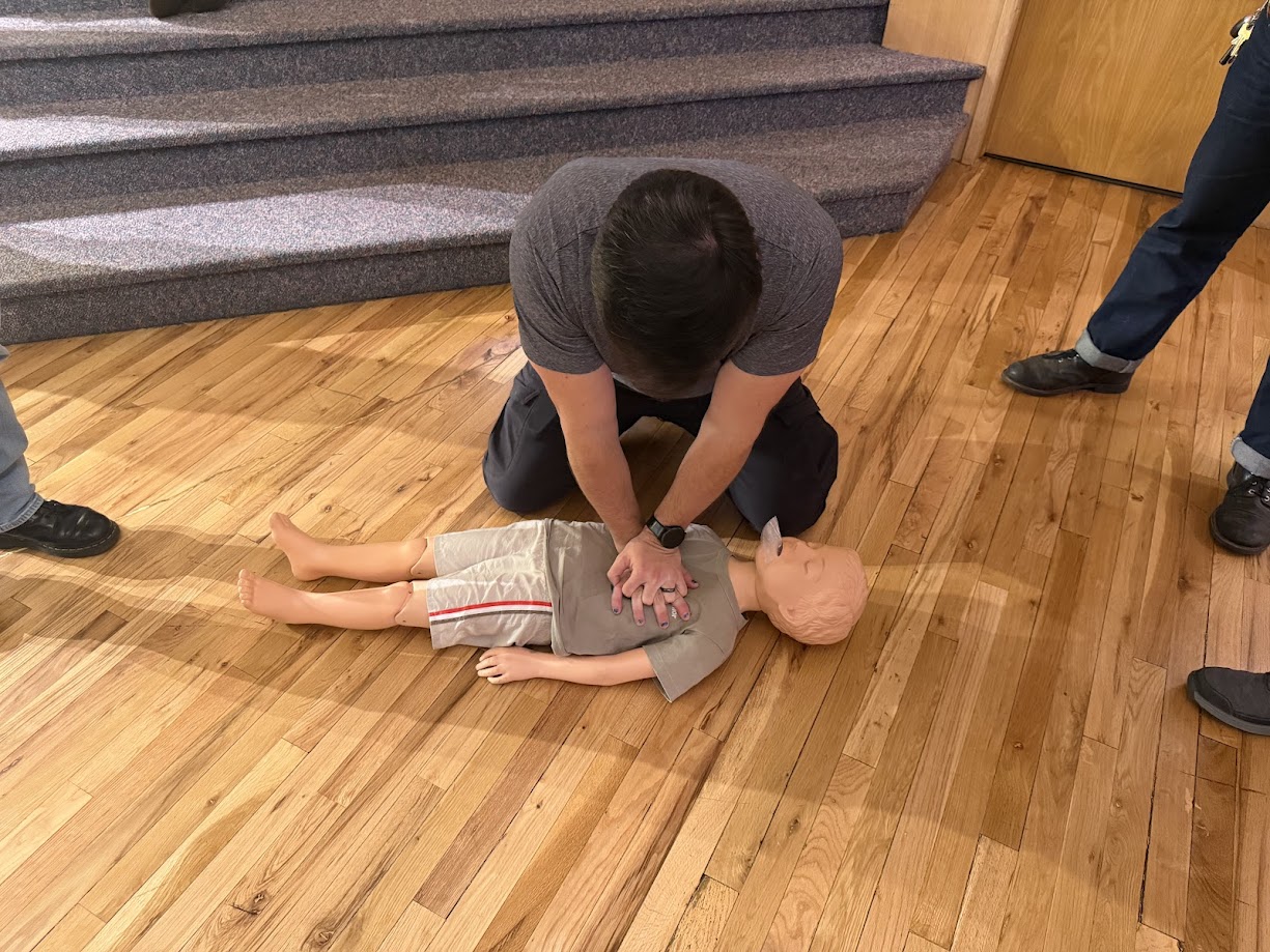 CPR chest compressions performed on a medical dummy